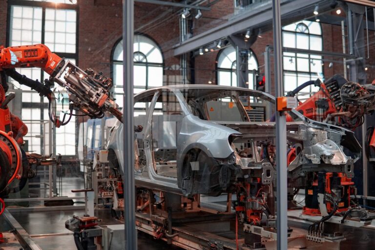 Image of a car passing through a robot-manned section in a manufacturing facility