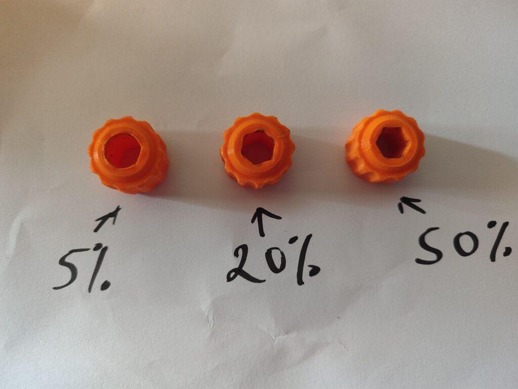 Three orange 3D printed hex nut drivers