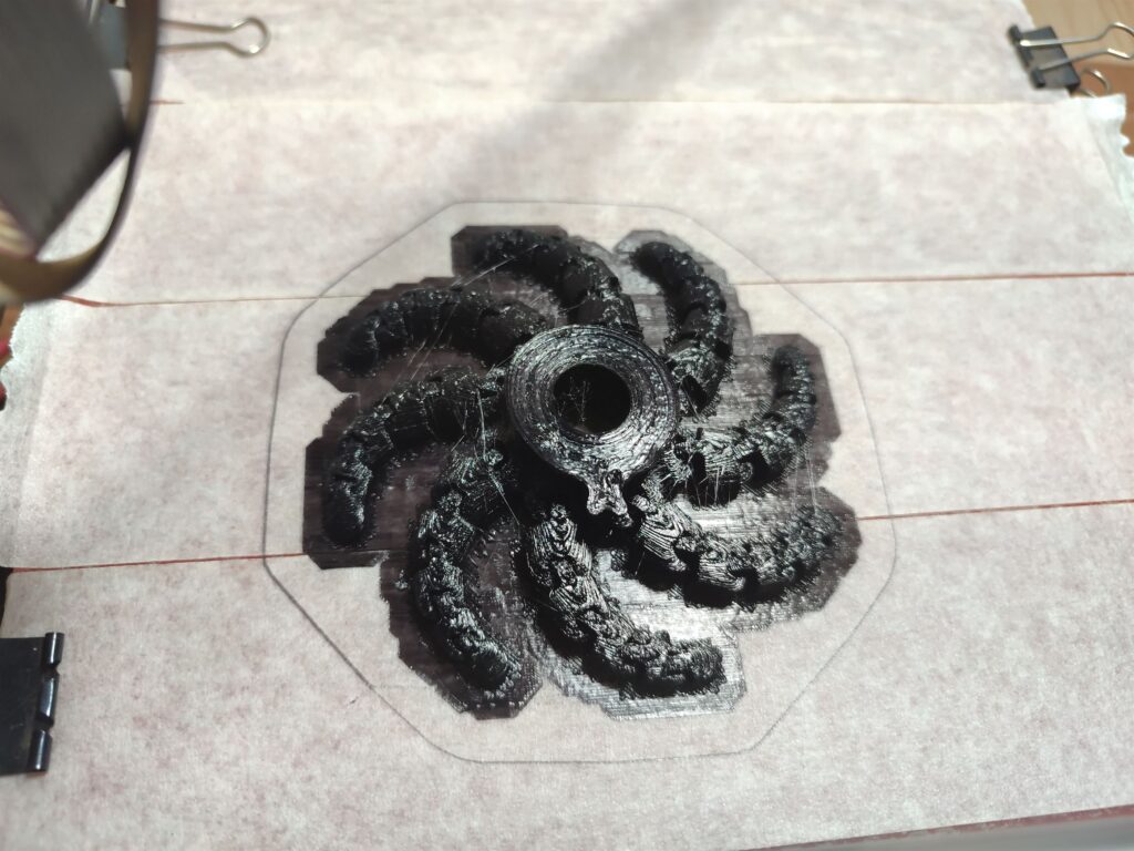 Black print-in-place octopus on print bed